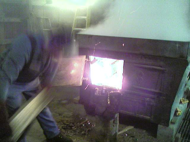 stoking the fire in the sugar house